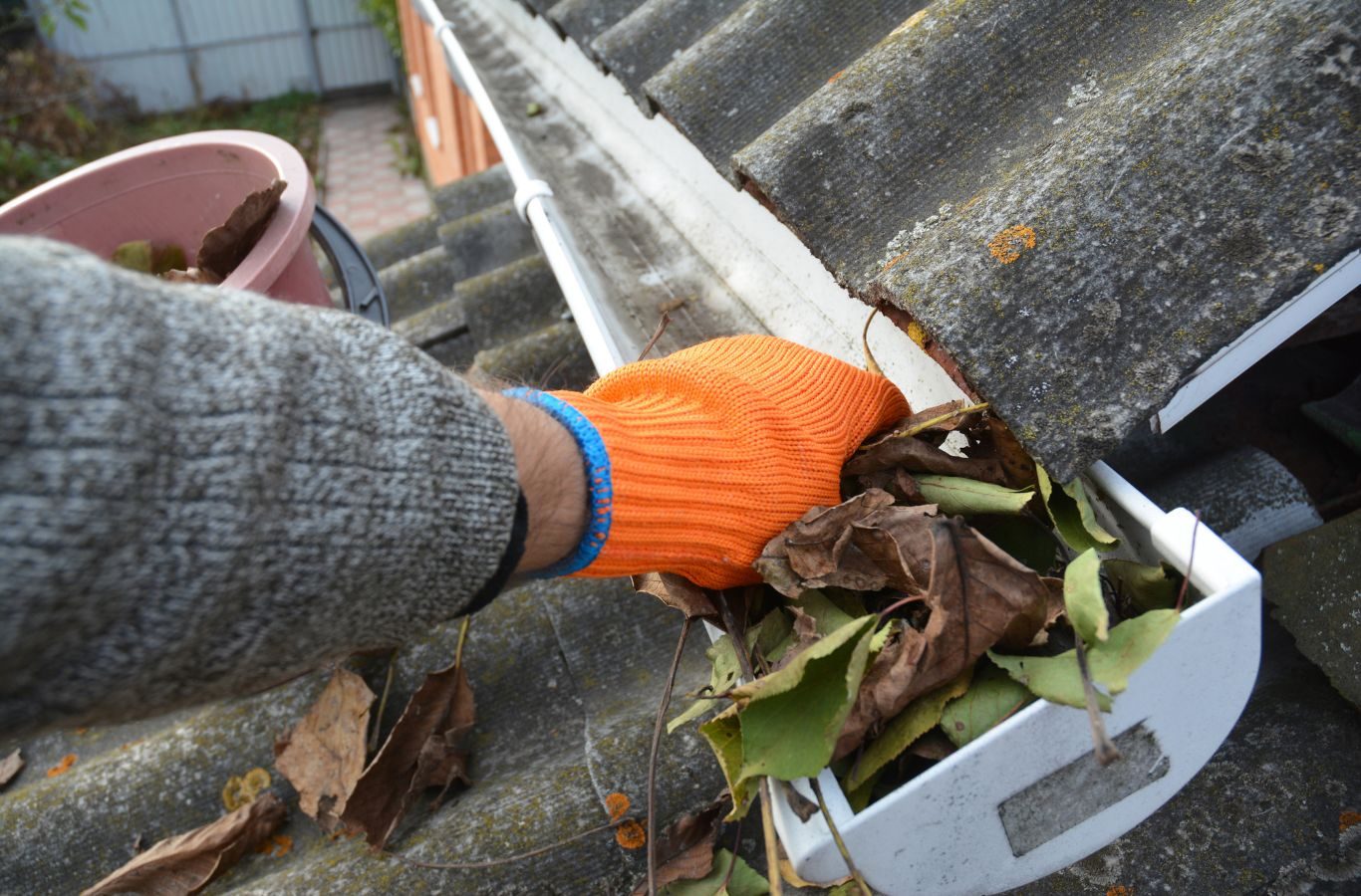 A Protek Gutters professional cleaning gutters in Springfield, MO, ensuring proper water flow and debris removal for a safer home.