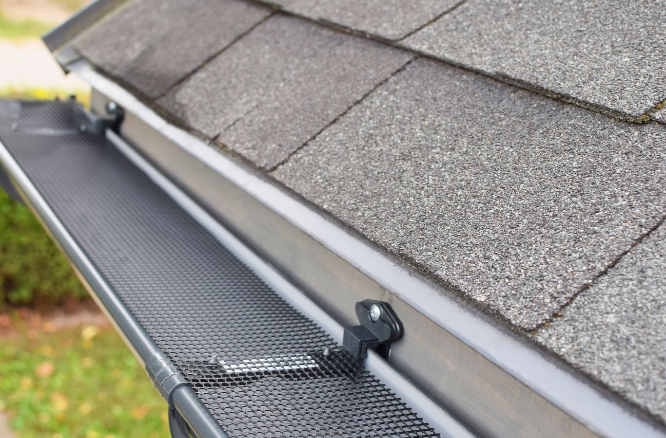 Protek Gutters team installing high-quality gutter guards on a Springfield, MO home, preventing debris buildup and ensuring water flows smoothly.