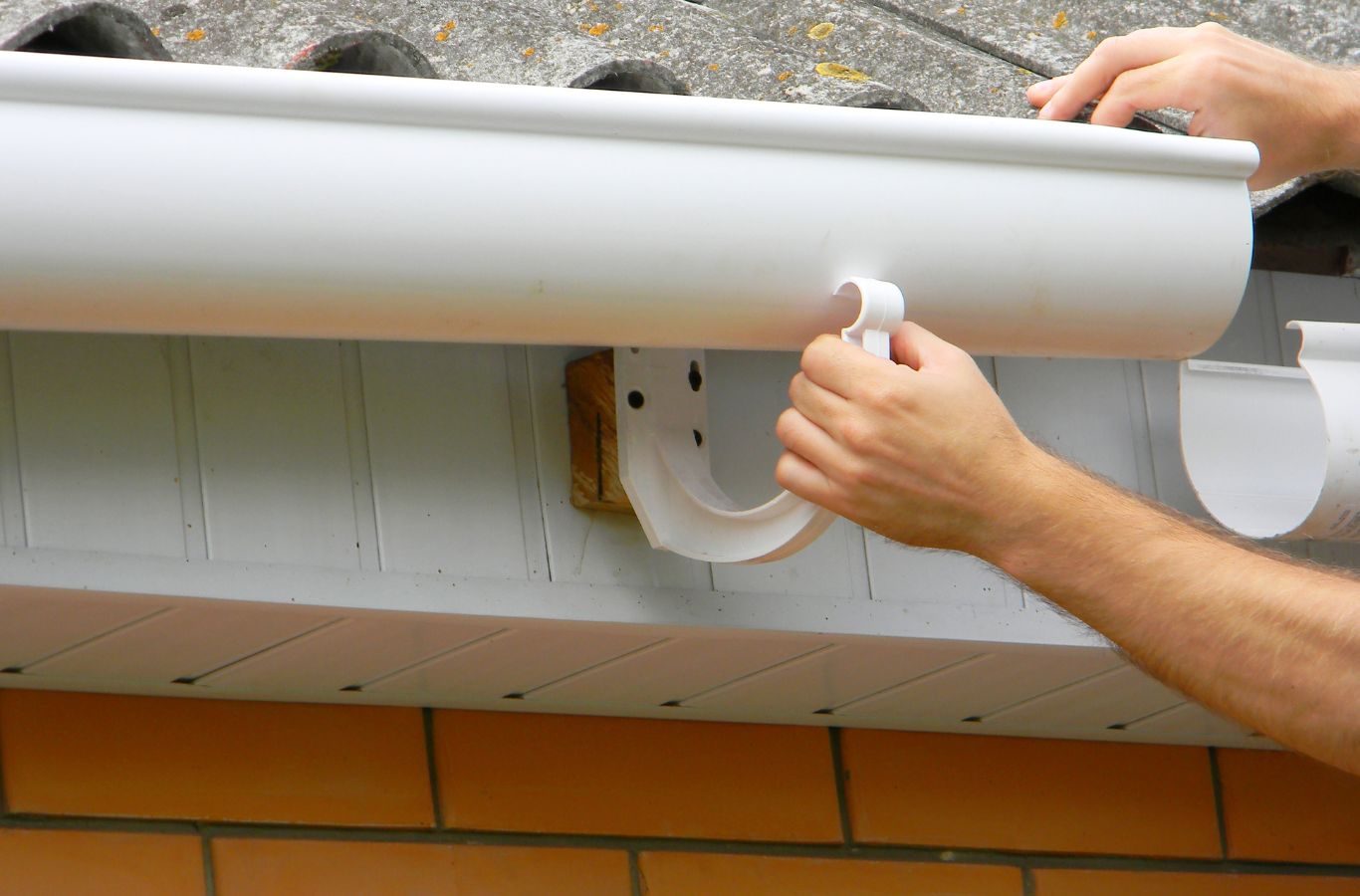 A Protek Gutters employee installing a new gutter system in Springfield, MO, ensuring proper protection from rainwater.